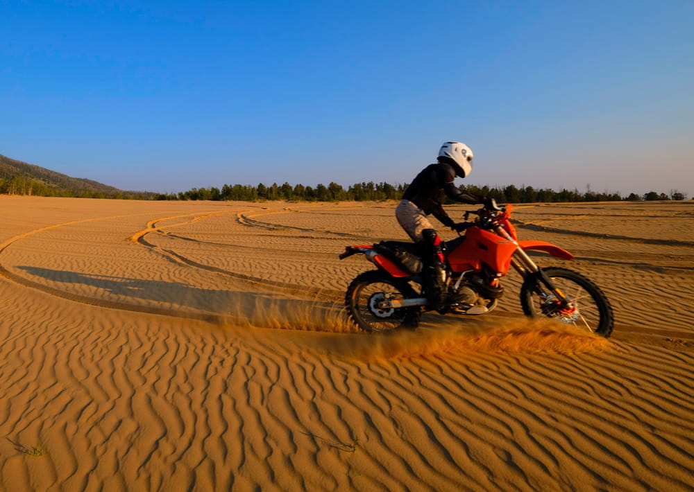 motorcycle riding on sand dunes