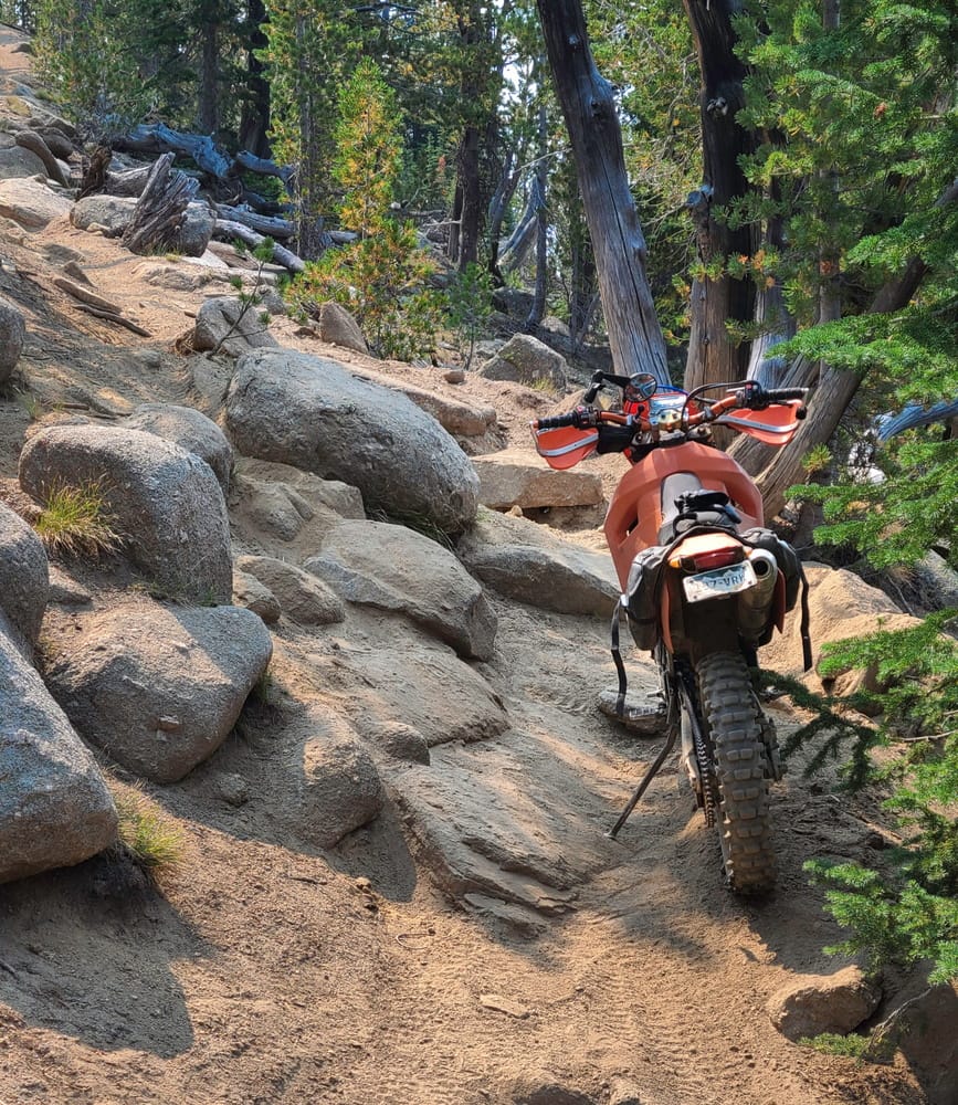 motorcycle parked on a rocky trail