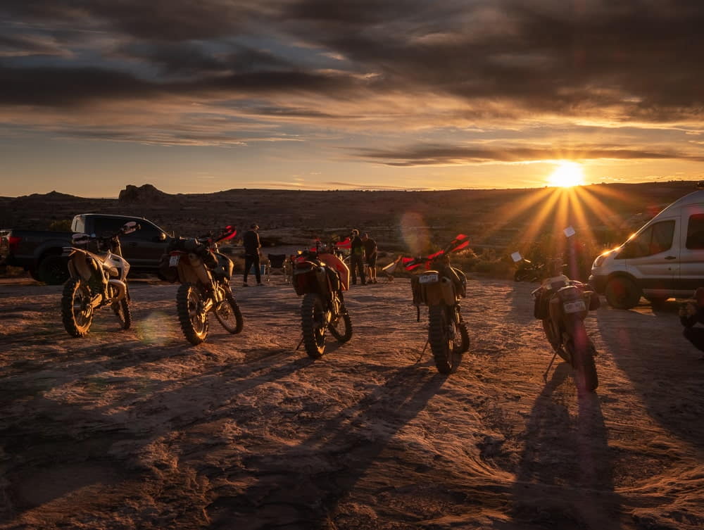 motorcycles parked against setting sun