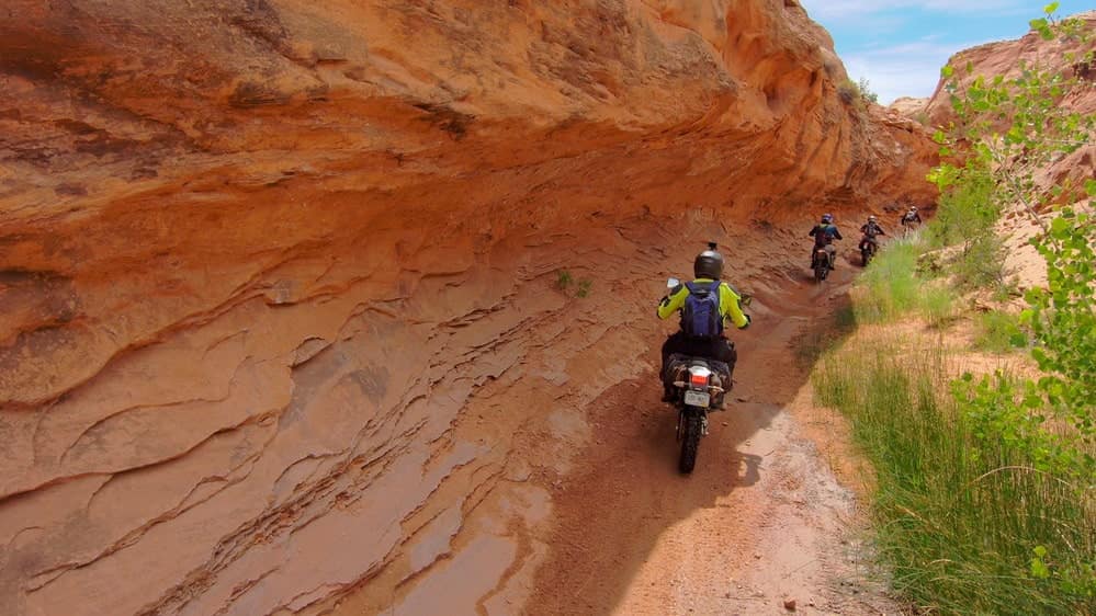 Riders going through a narrow canyon