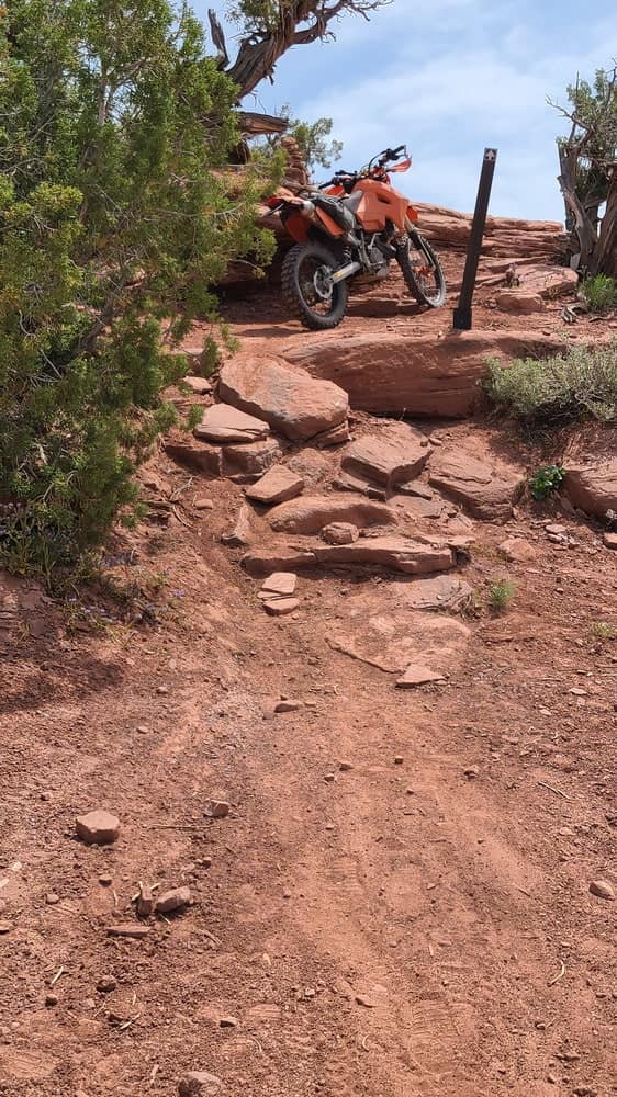 motorcycle parked atop stacked rocks
