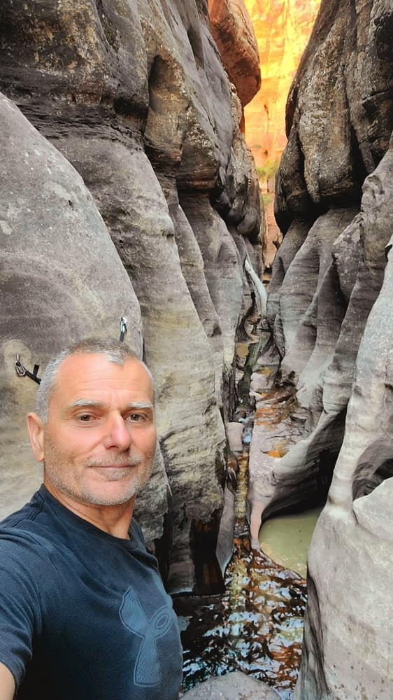 selfie in a narrow canhyong with water flowing through it