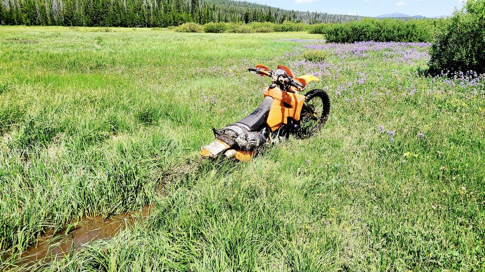 motorcycle stuck in muddy creek