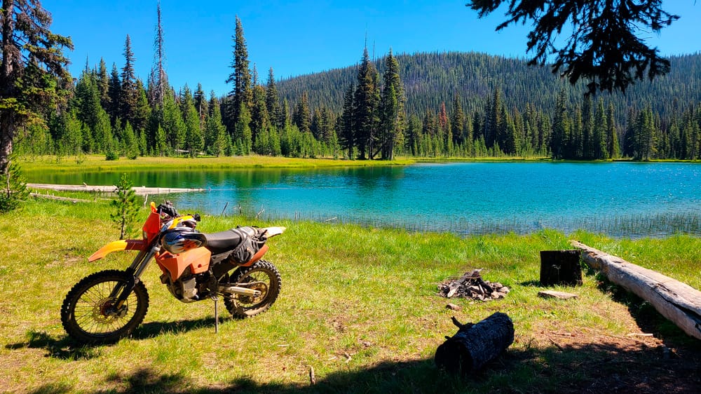 motorycle parked next to an alpine lake