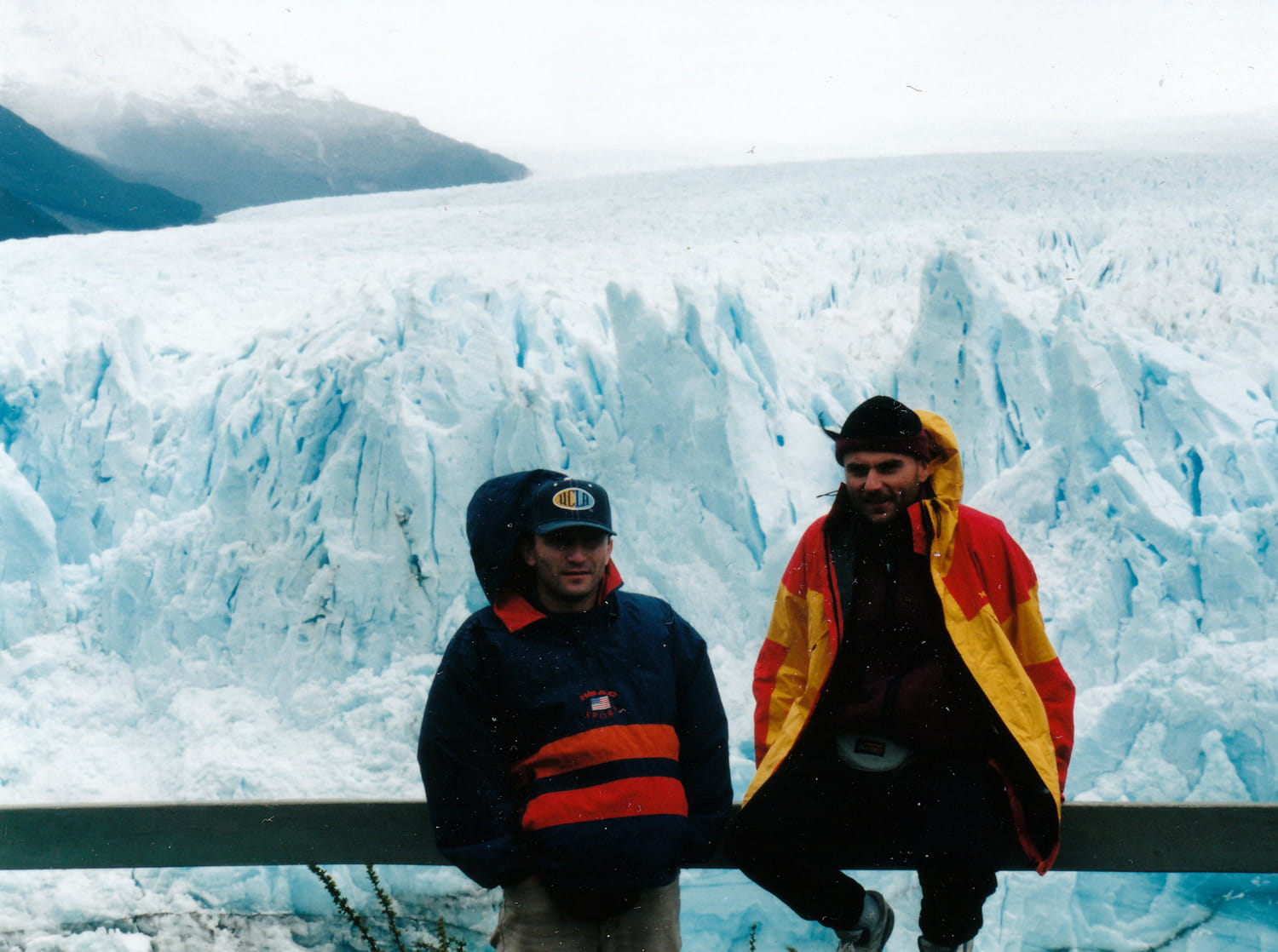 two people in front of a glacier 