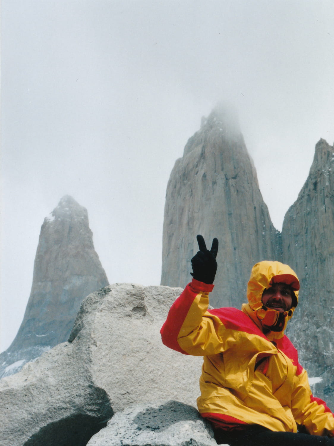 person with three rock towers behind