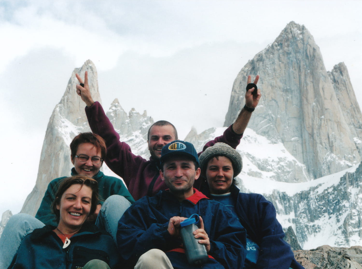 five people in front of big rock monoliths 