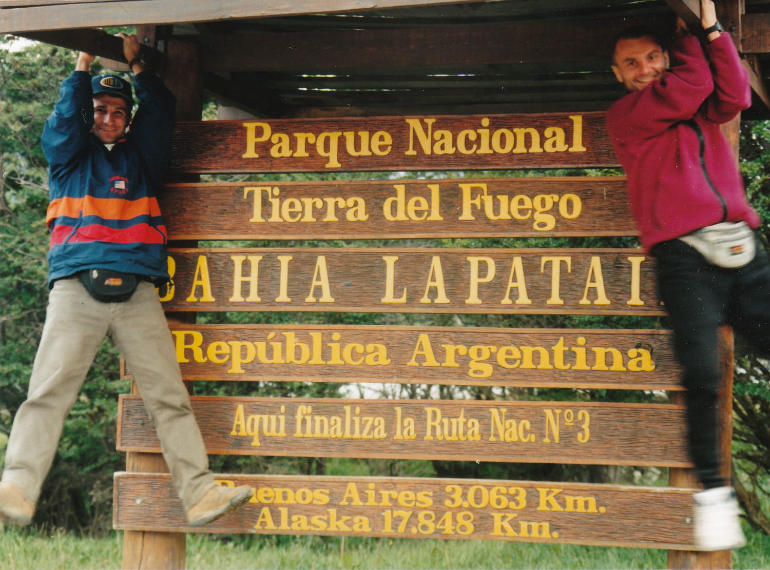 two guys next to the famous sign outside Ushuaia