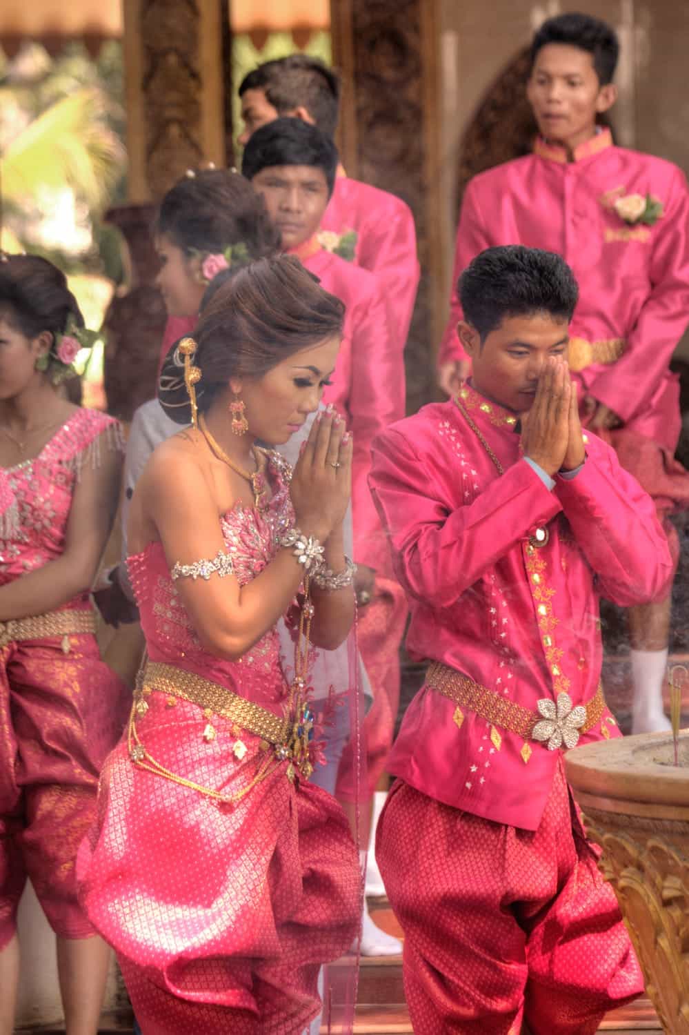 a group of people in traditional dresses performing a ceremony