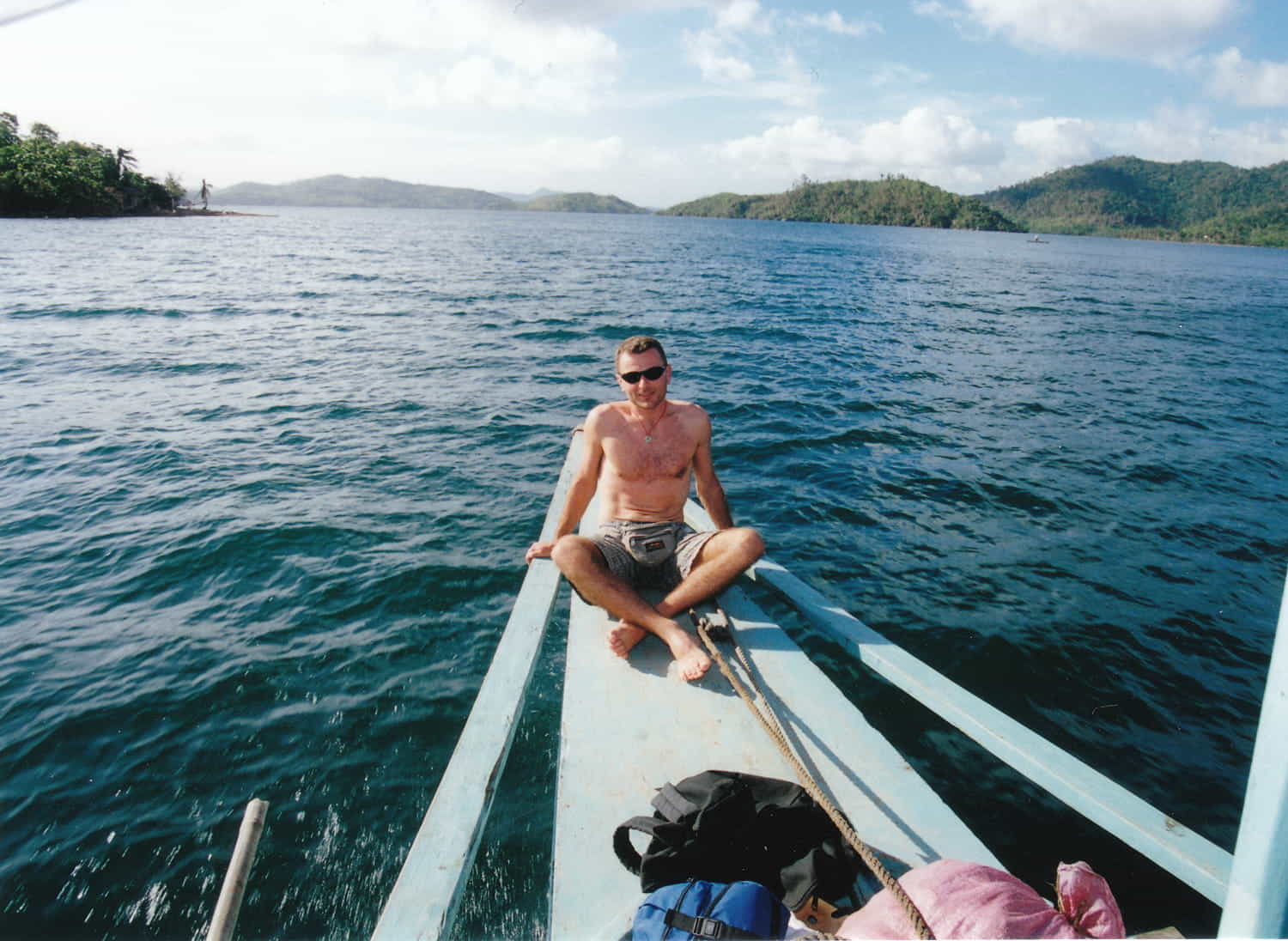 a person sitting on a bow of a boat