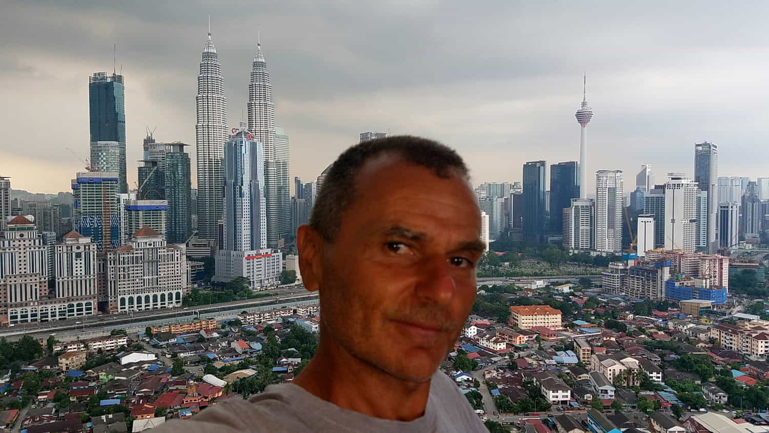 a selfie with a sprawling city behind