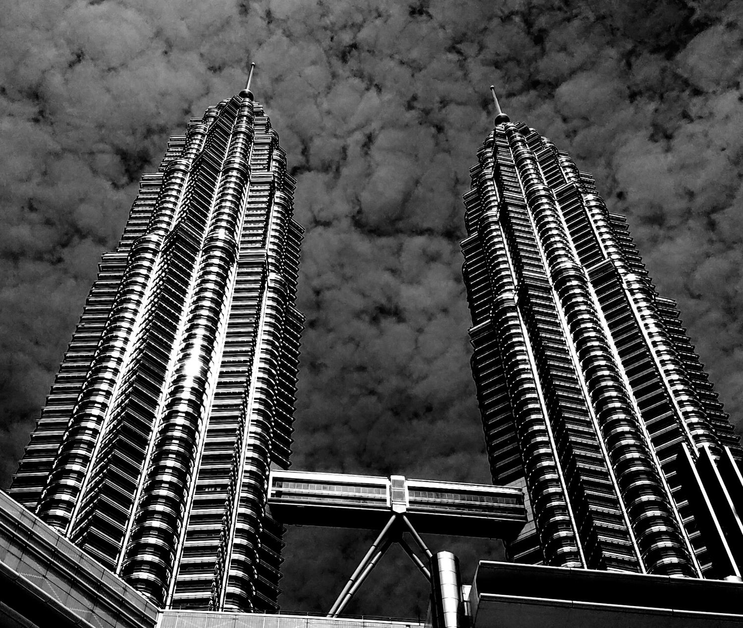 a black and white photo of Petronas towers 