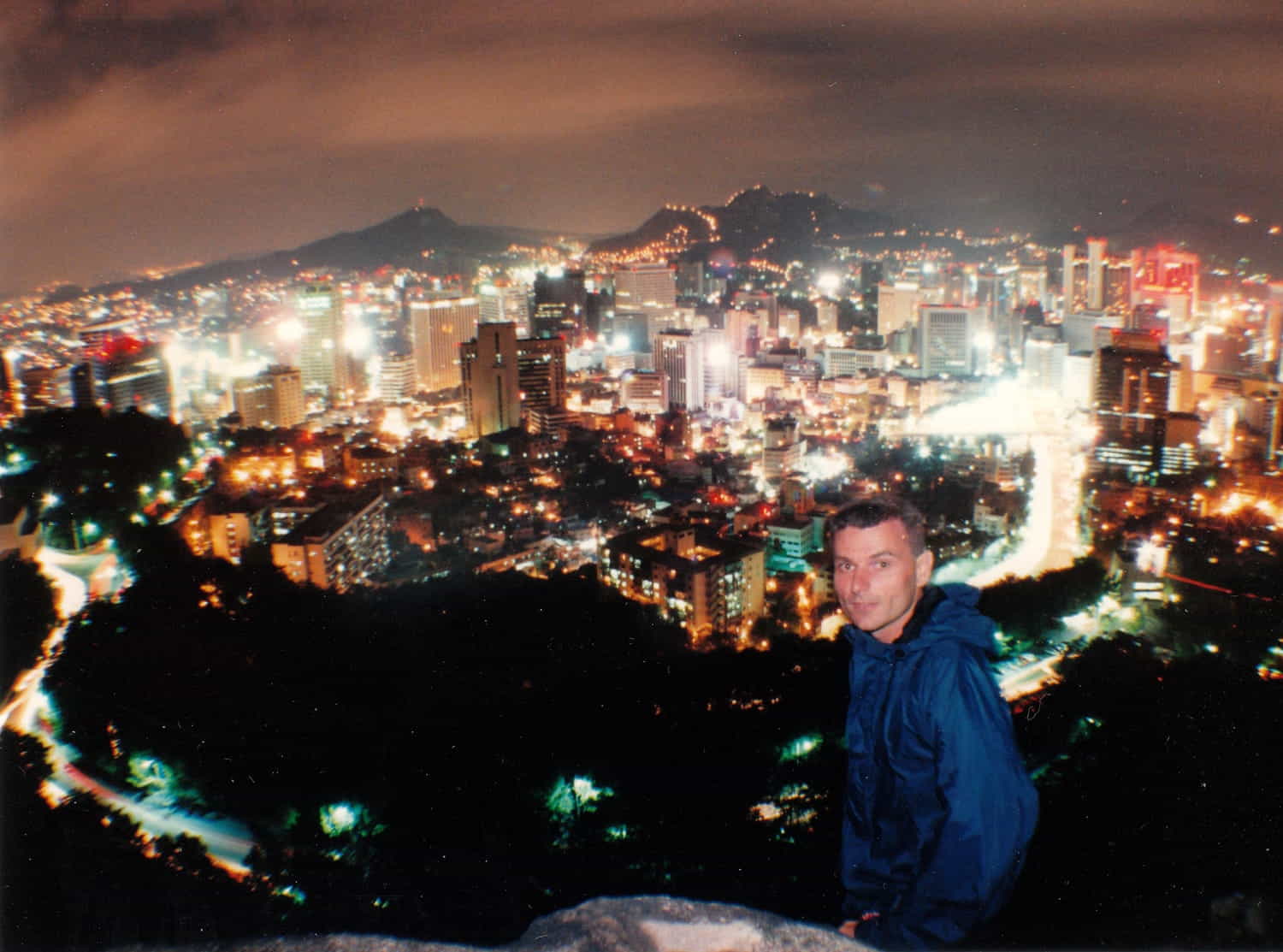 person high above glittering lights of a big city