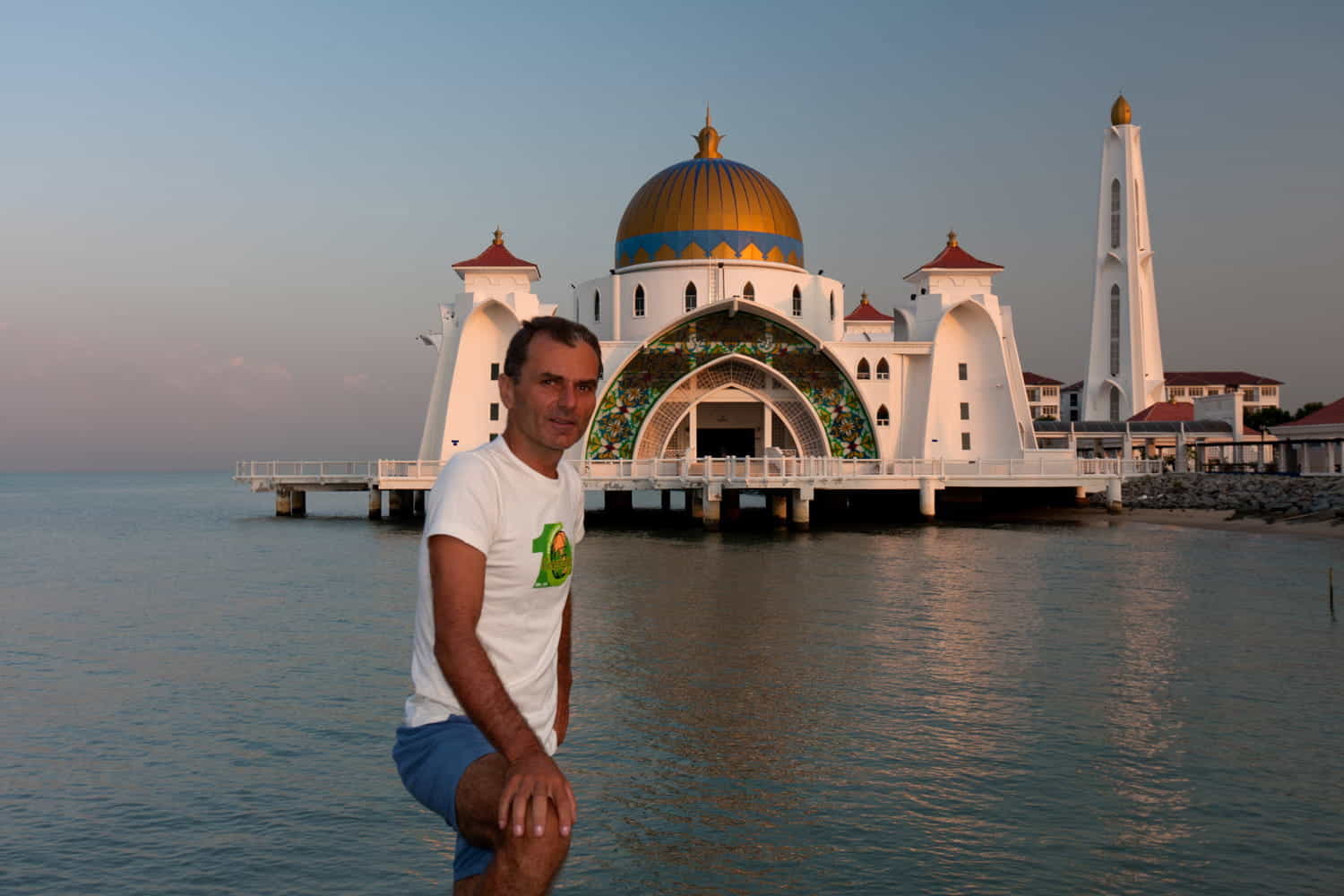 person in front of a mosque over the water 