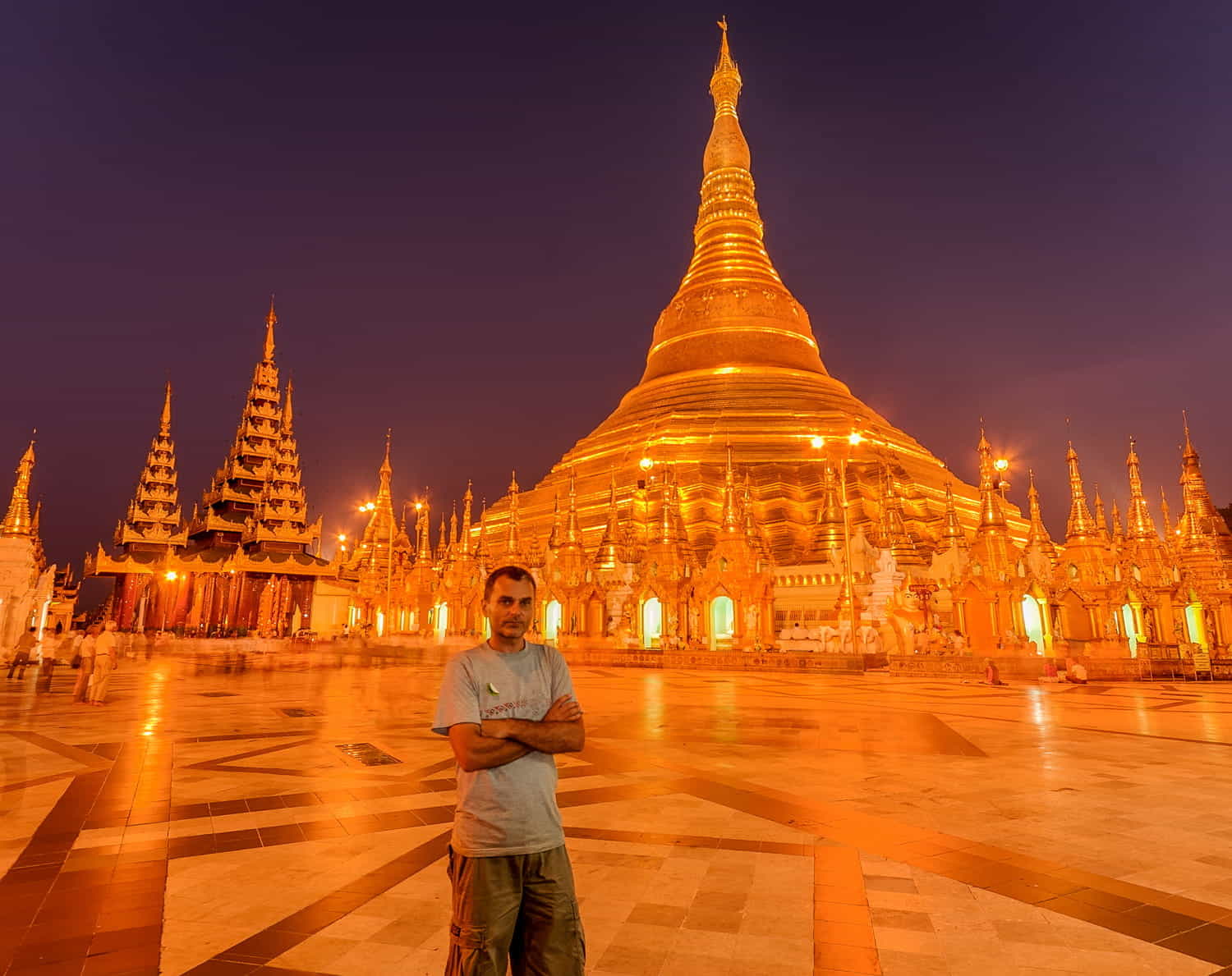 a person in a temple comples with numerous golden roofs