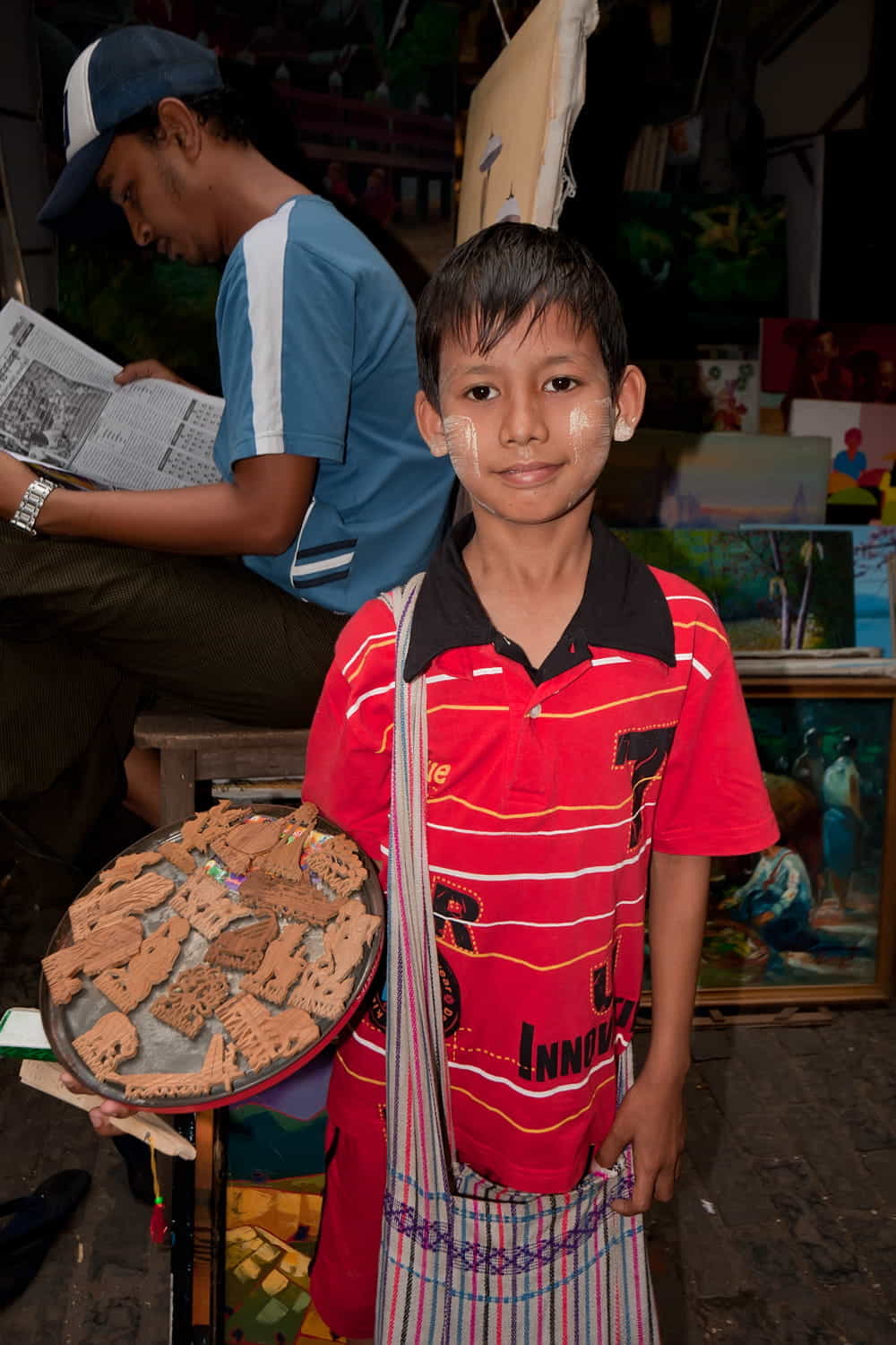 a boy selling souvenirs