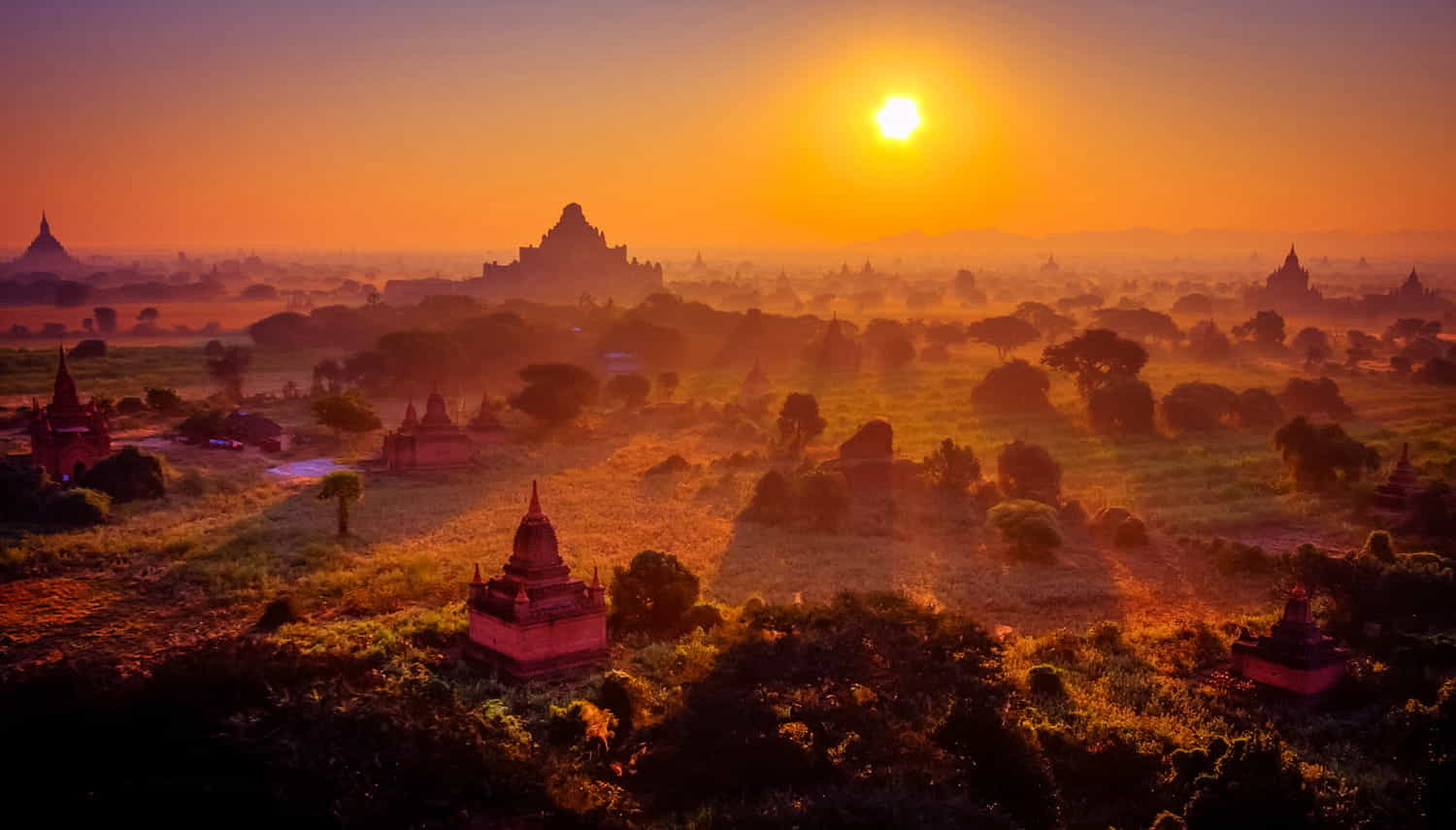 a low sun over temple filled valley