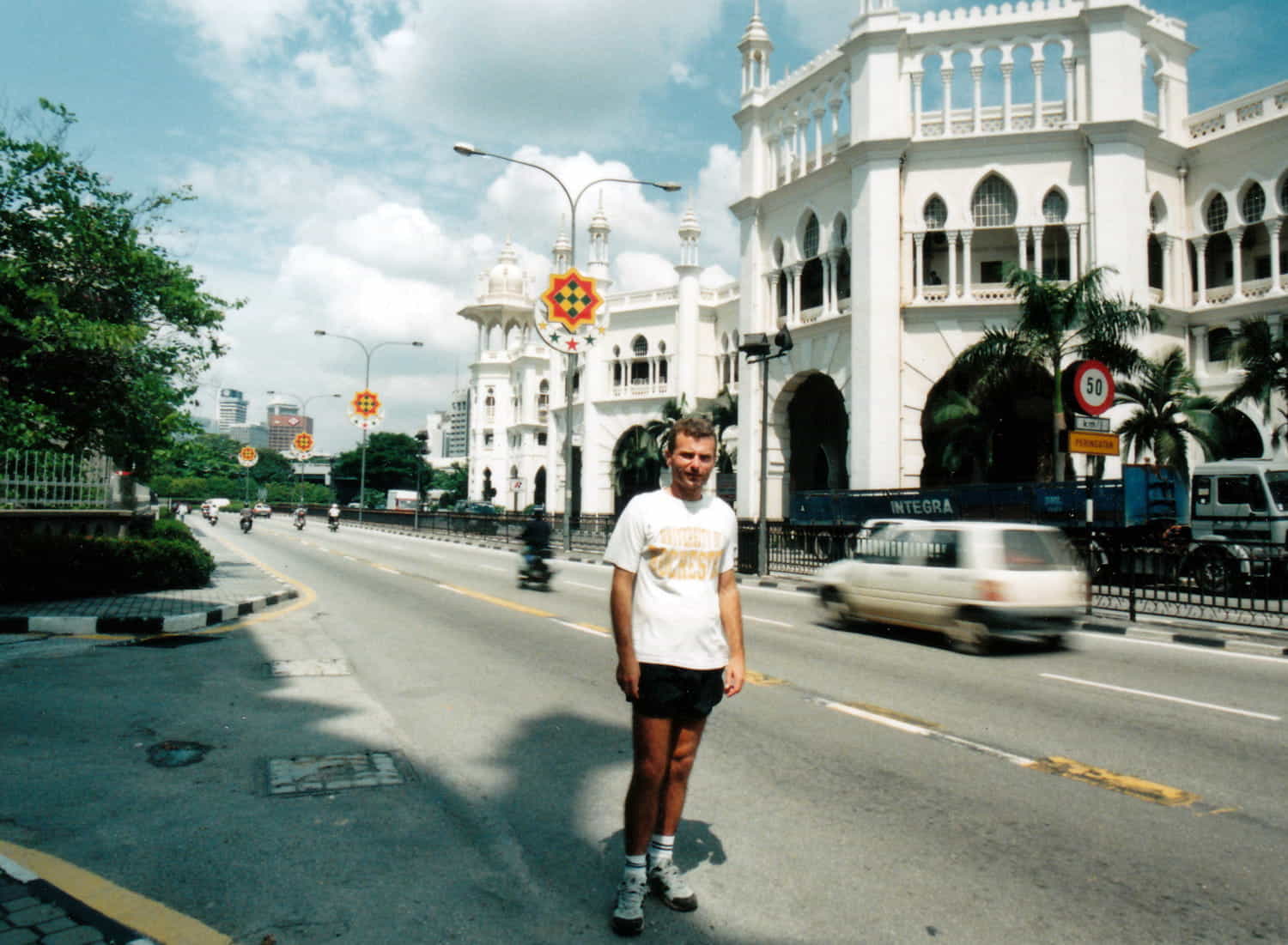 a person in front of a islamic style white building