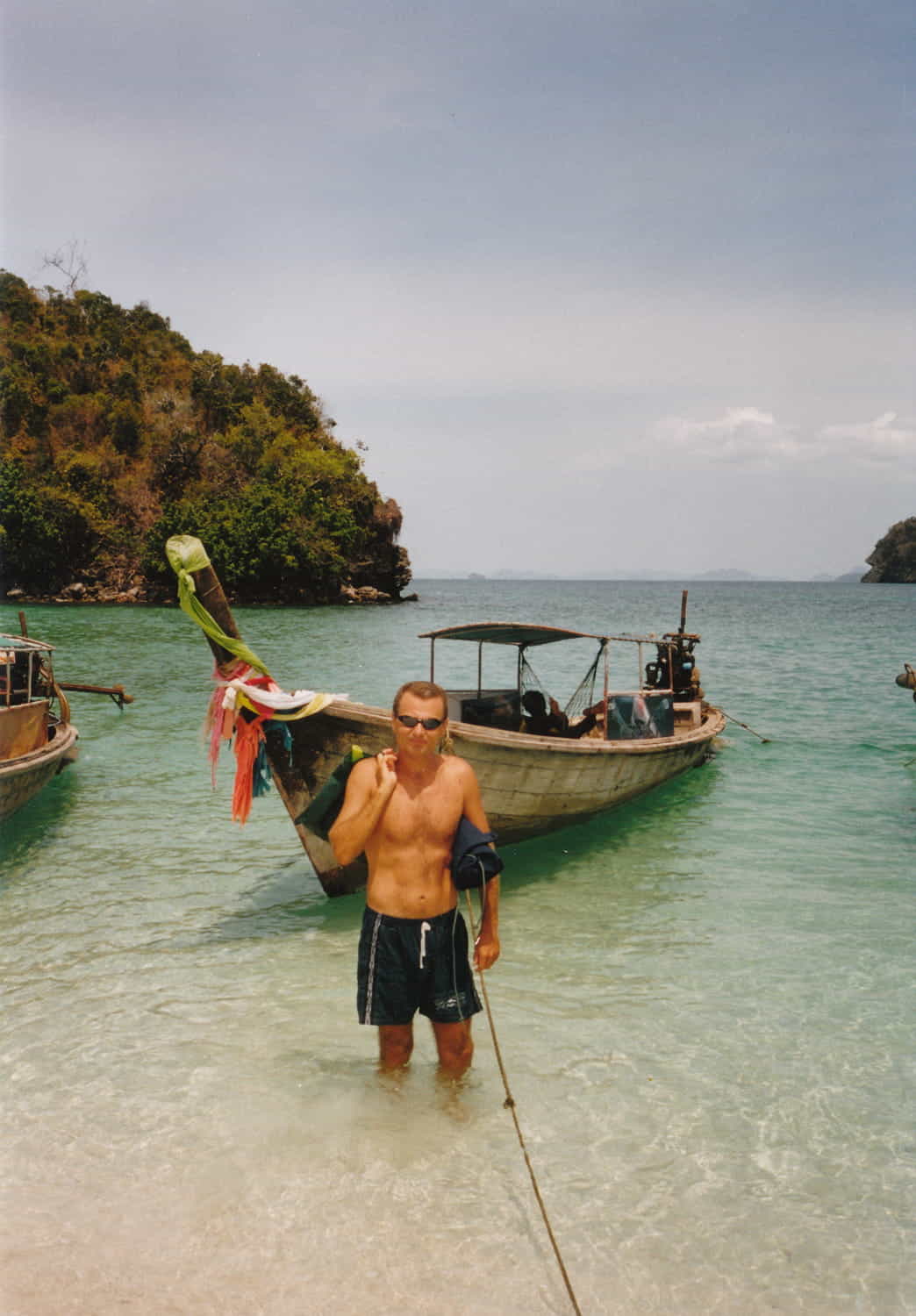 a person in shallow water next to a boat