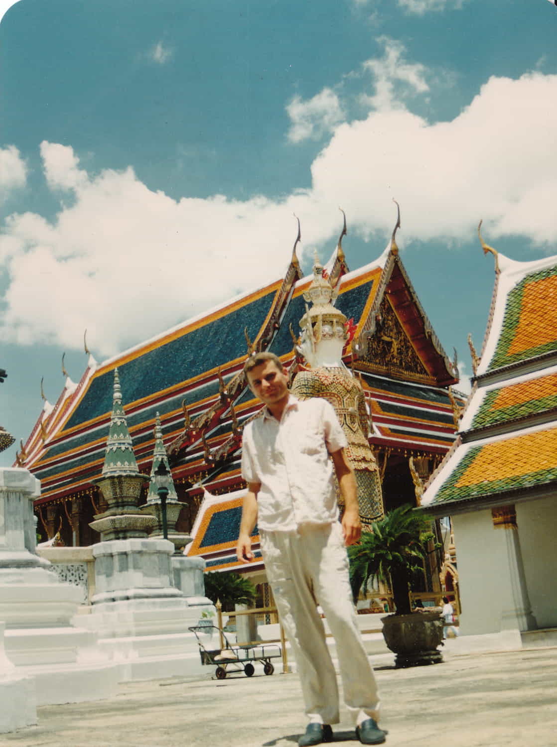 a person posing in front of a temple