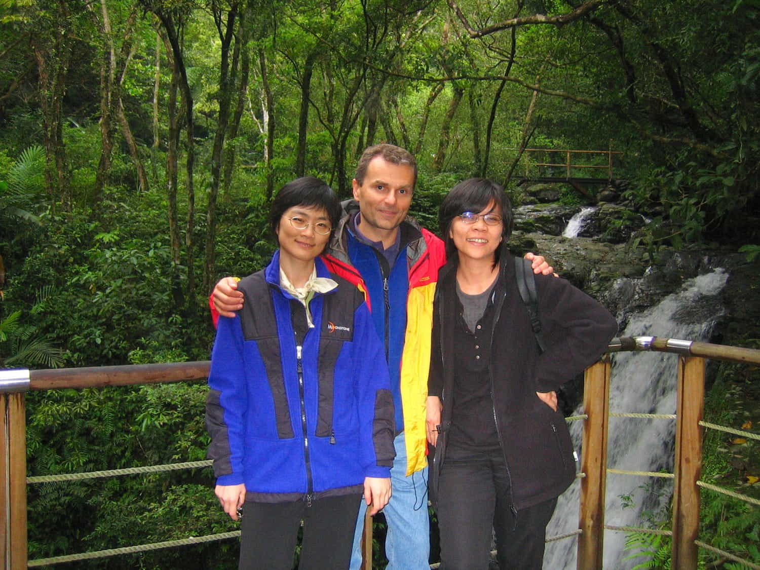 three people in a forest