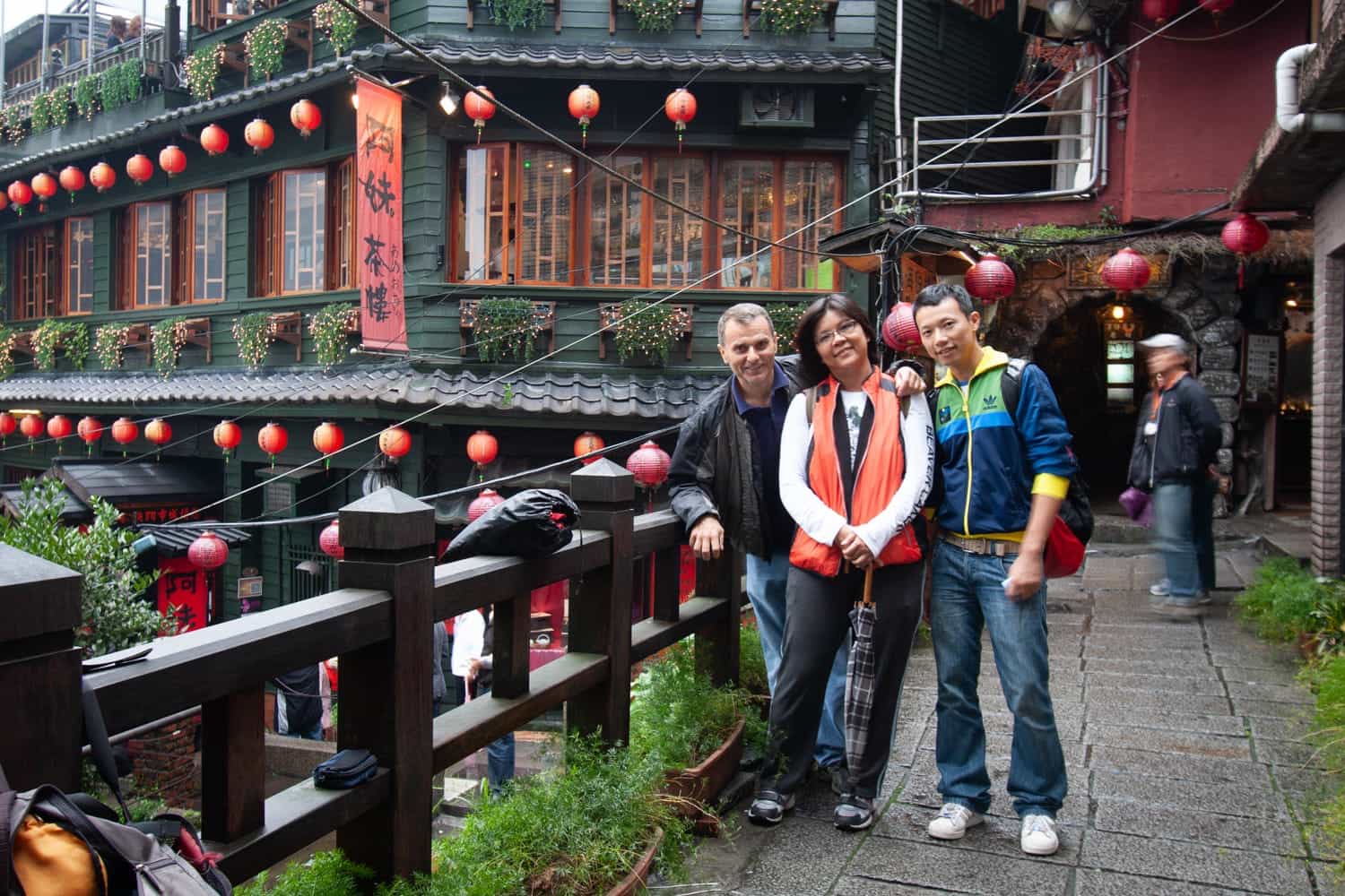  three people in a traditional chinese village