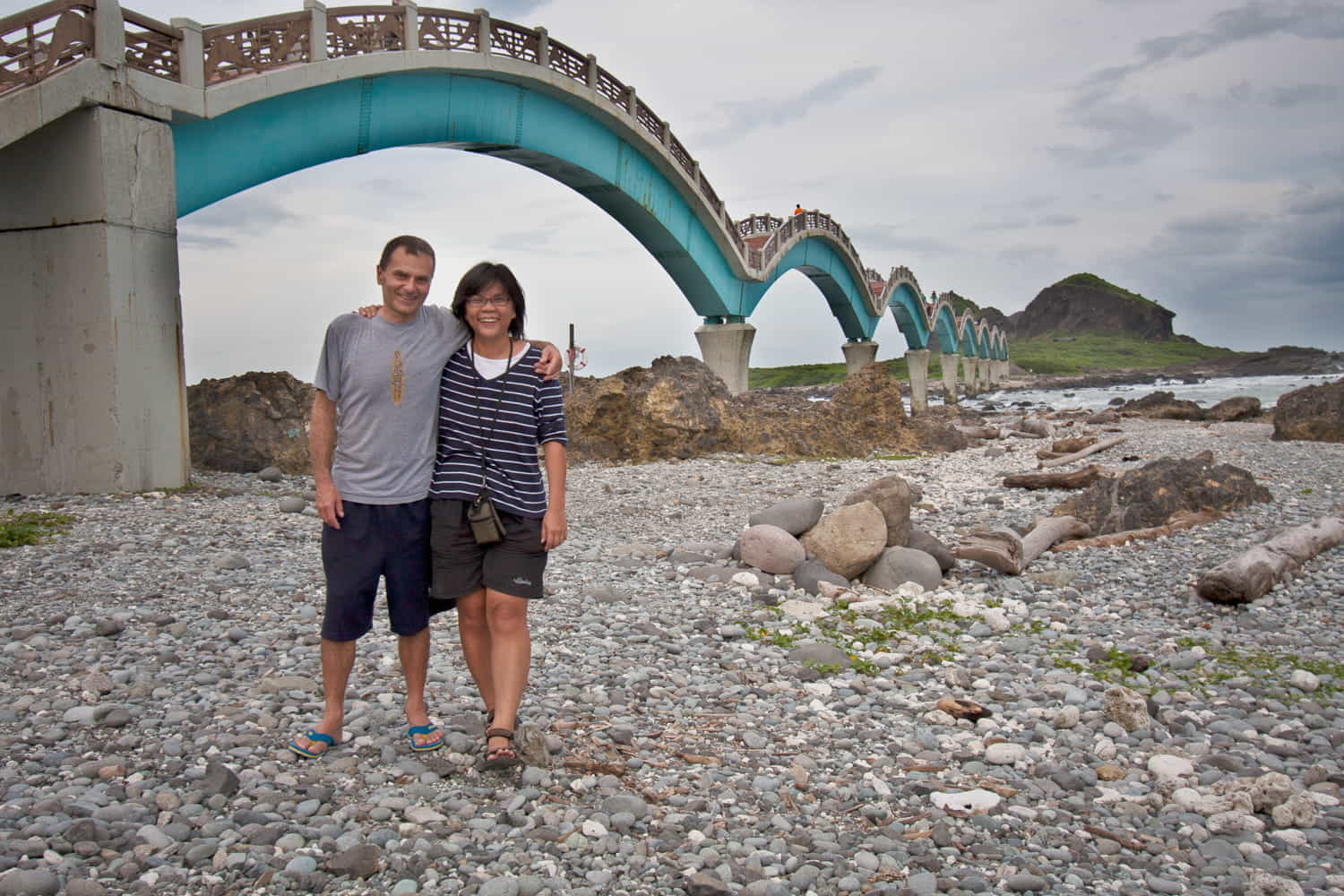  two people next to a bridge