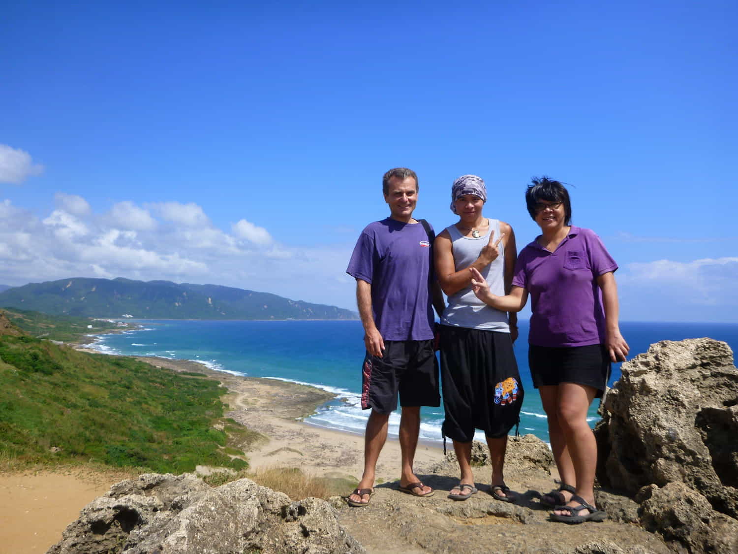  three people with a long beach behind