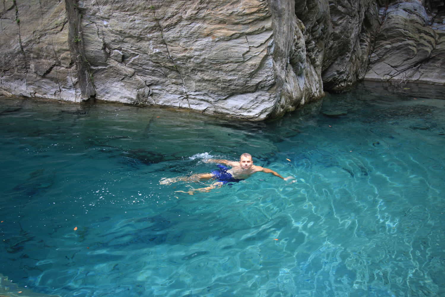 person swimming in turquoise water