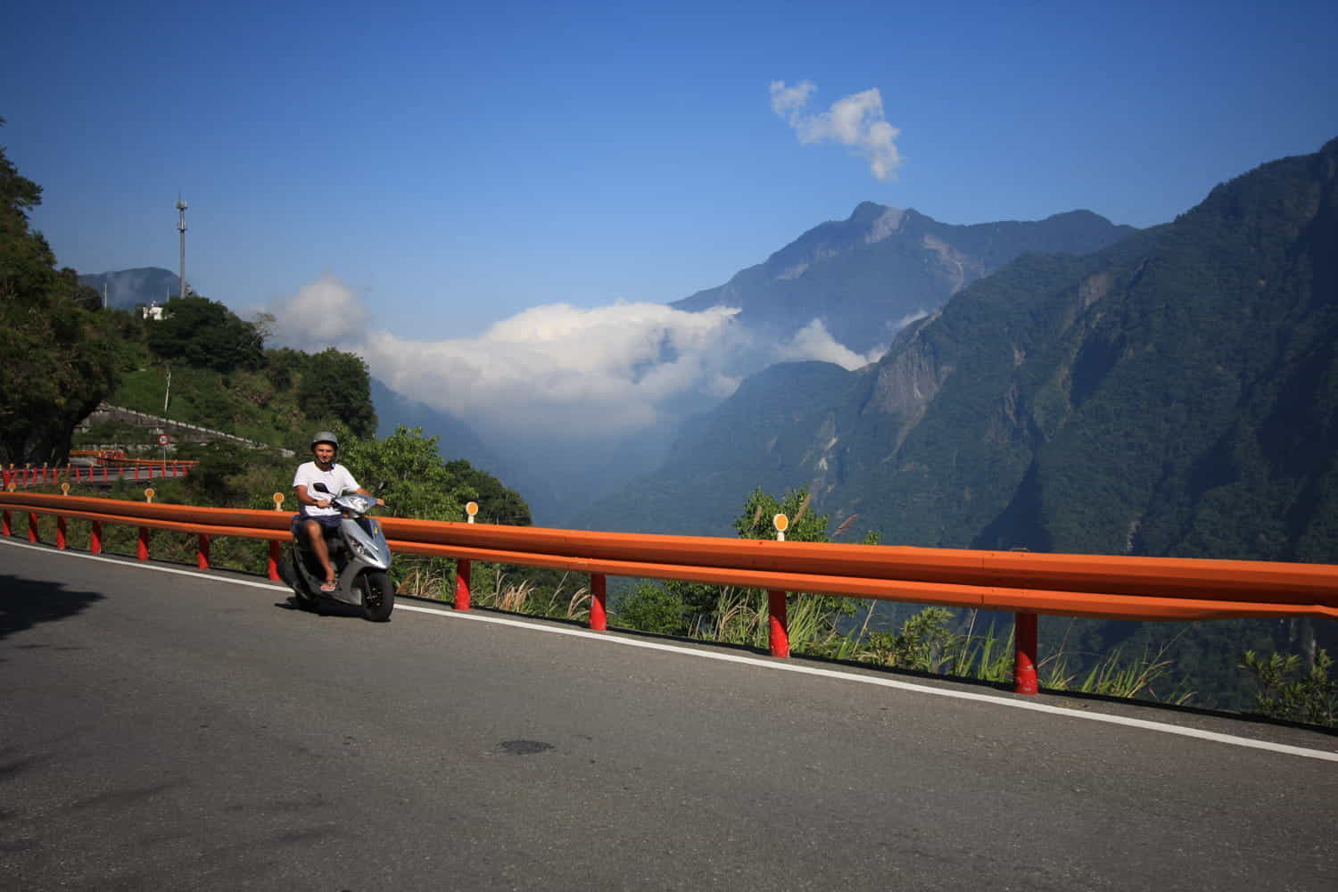 rider on a scooter riding along a twisty mountain road