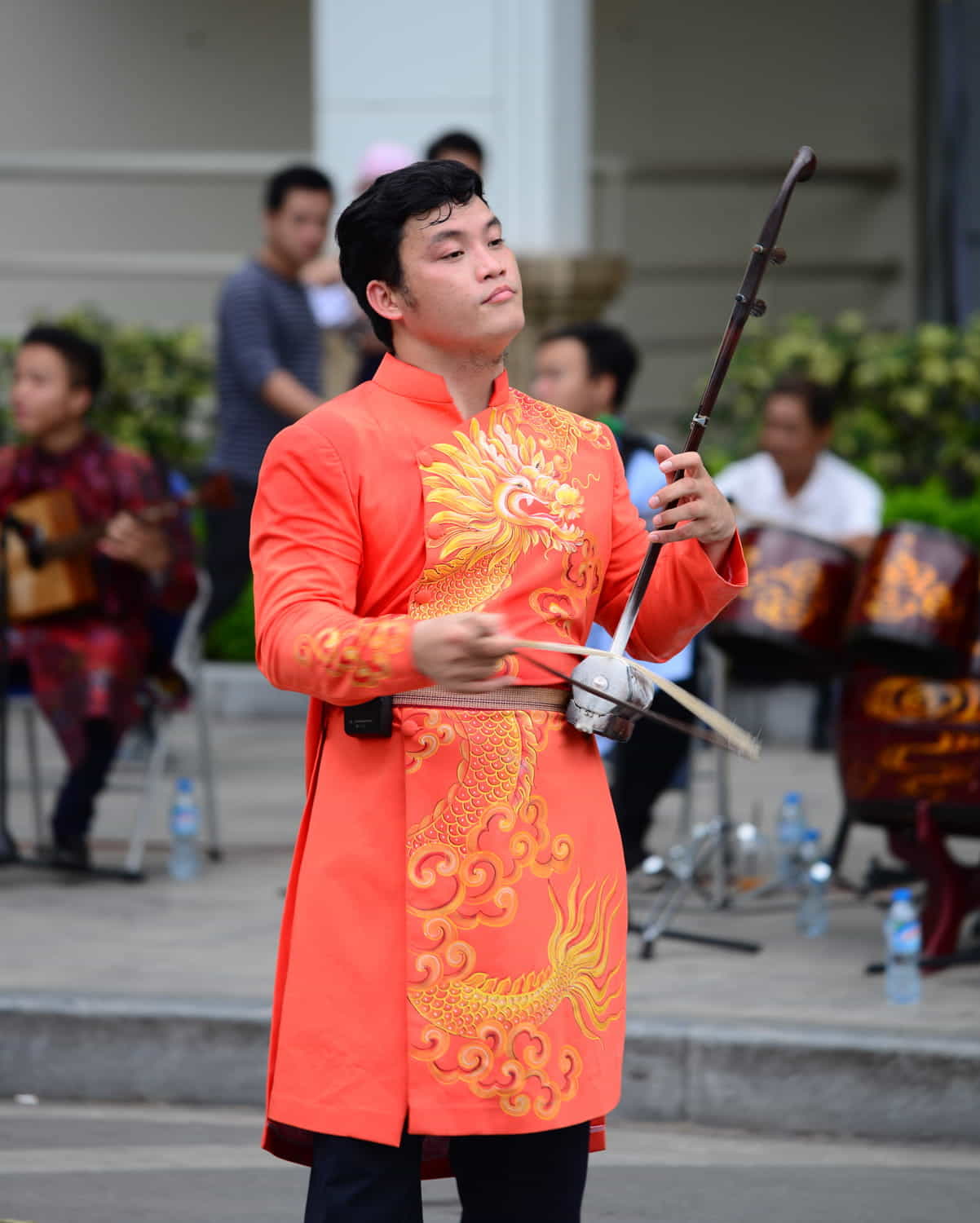 a musician in bright red coat