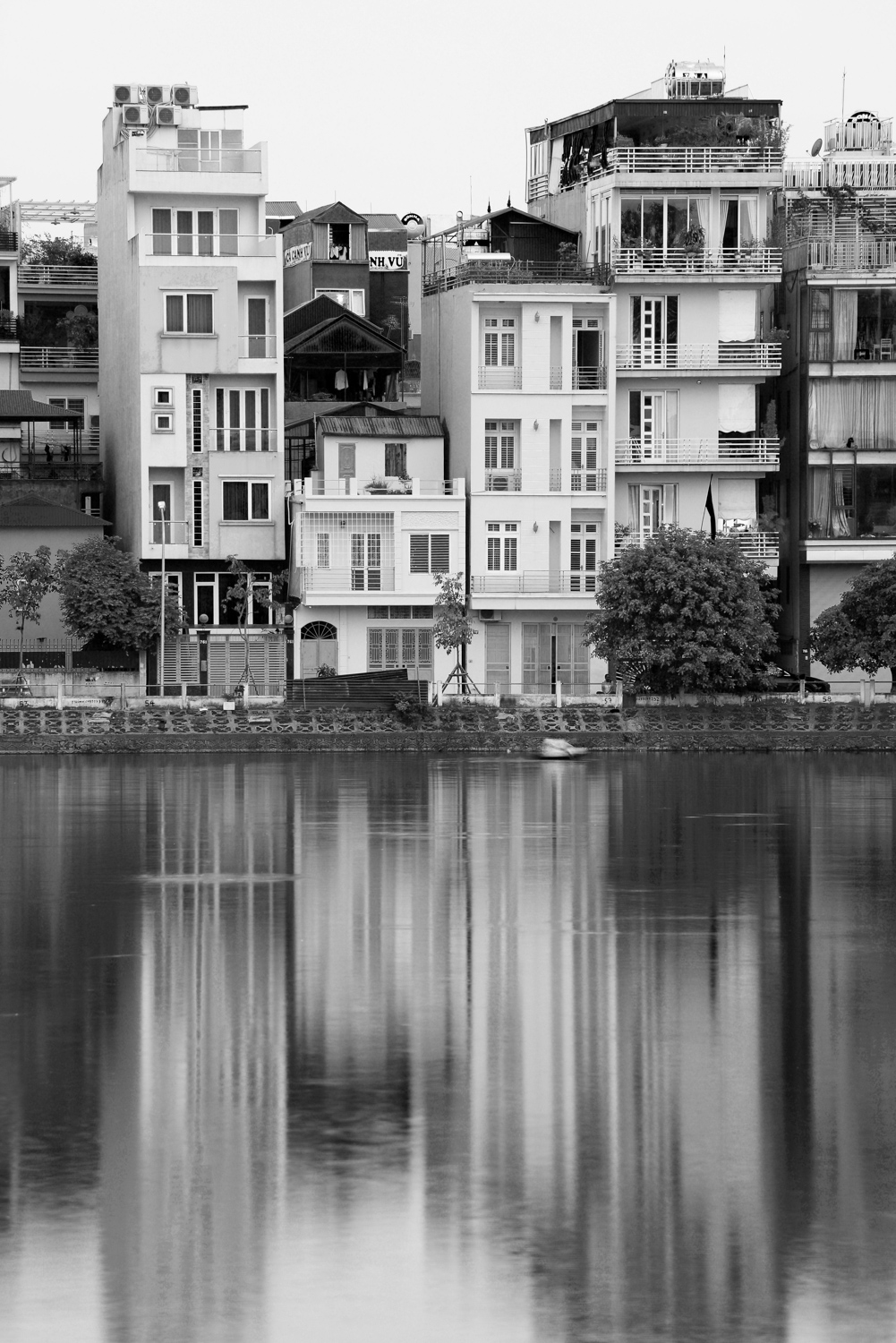 a row of houses and their reflections in water