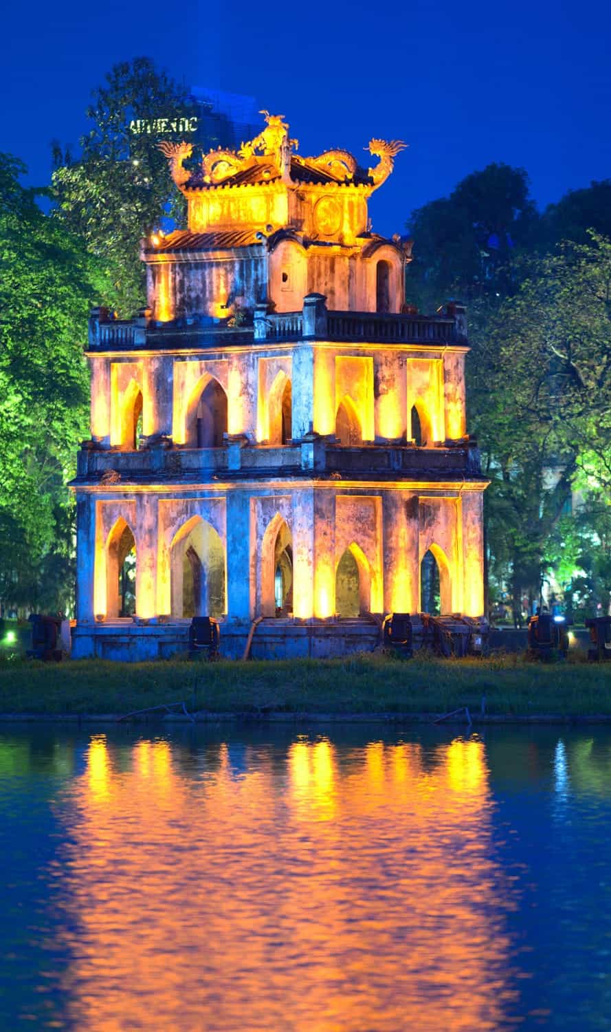 an illuminated old pagoda at dusk