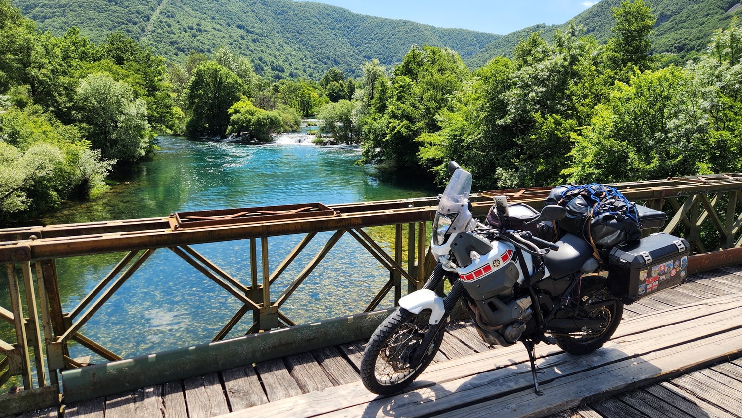 motorcycle on a bridge over a freen river 