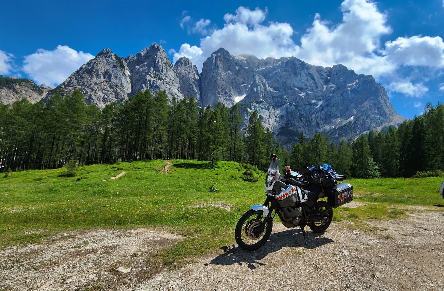  motorcycle parked with rock cliffs behind