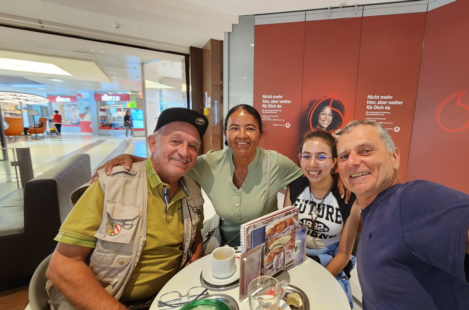 selfie of four people in a cafe