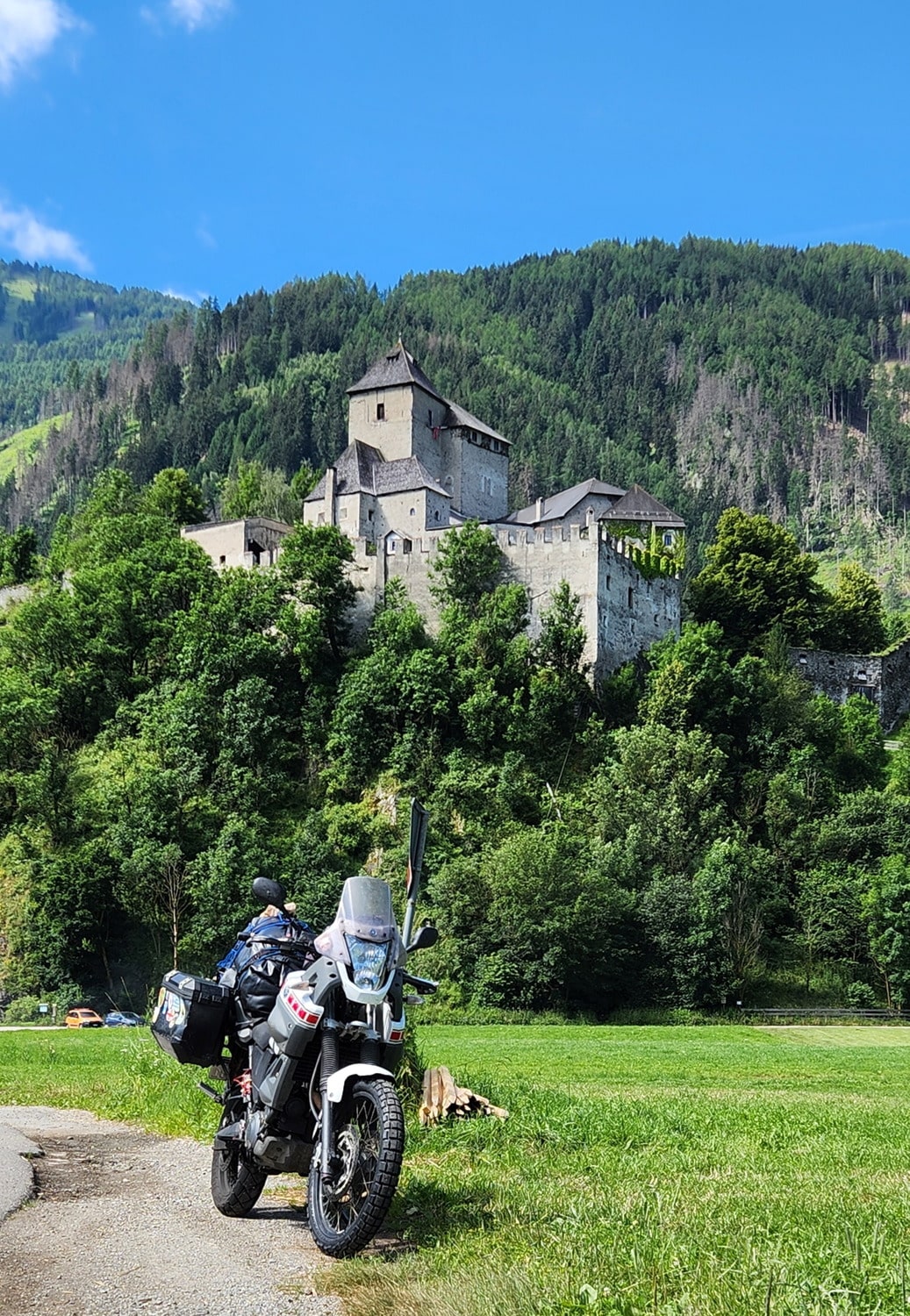 motorcycle parked with a castle behind it