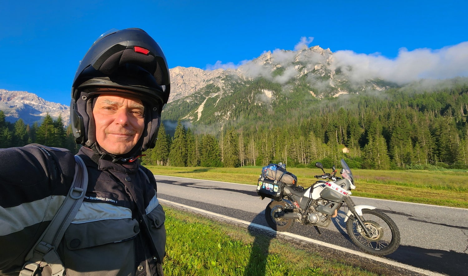 selfie with motorcycle and mountain behind