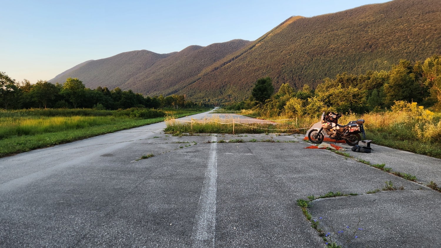 motorcycle and a tent on a damaged runway