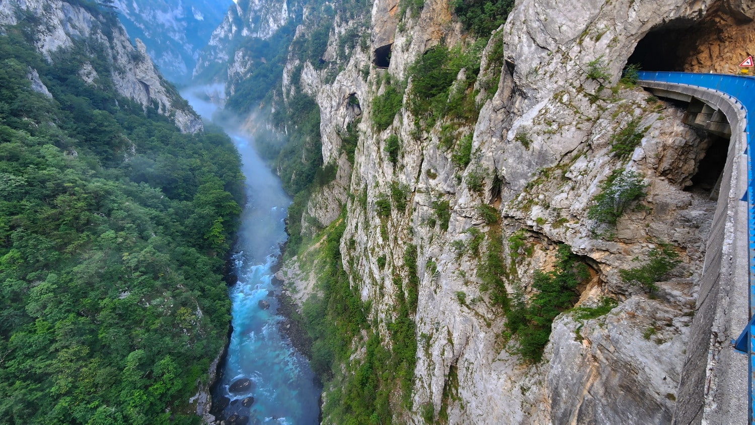 view of a deep canyon from a curved bridge