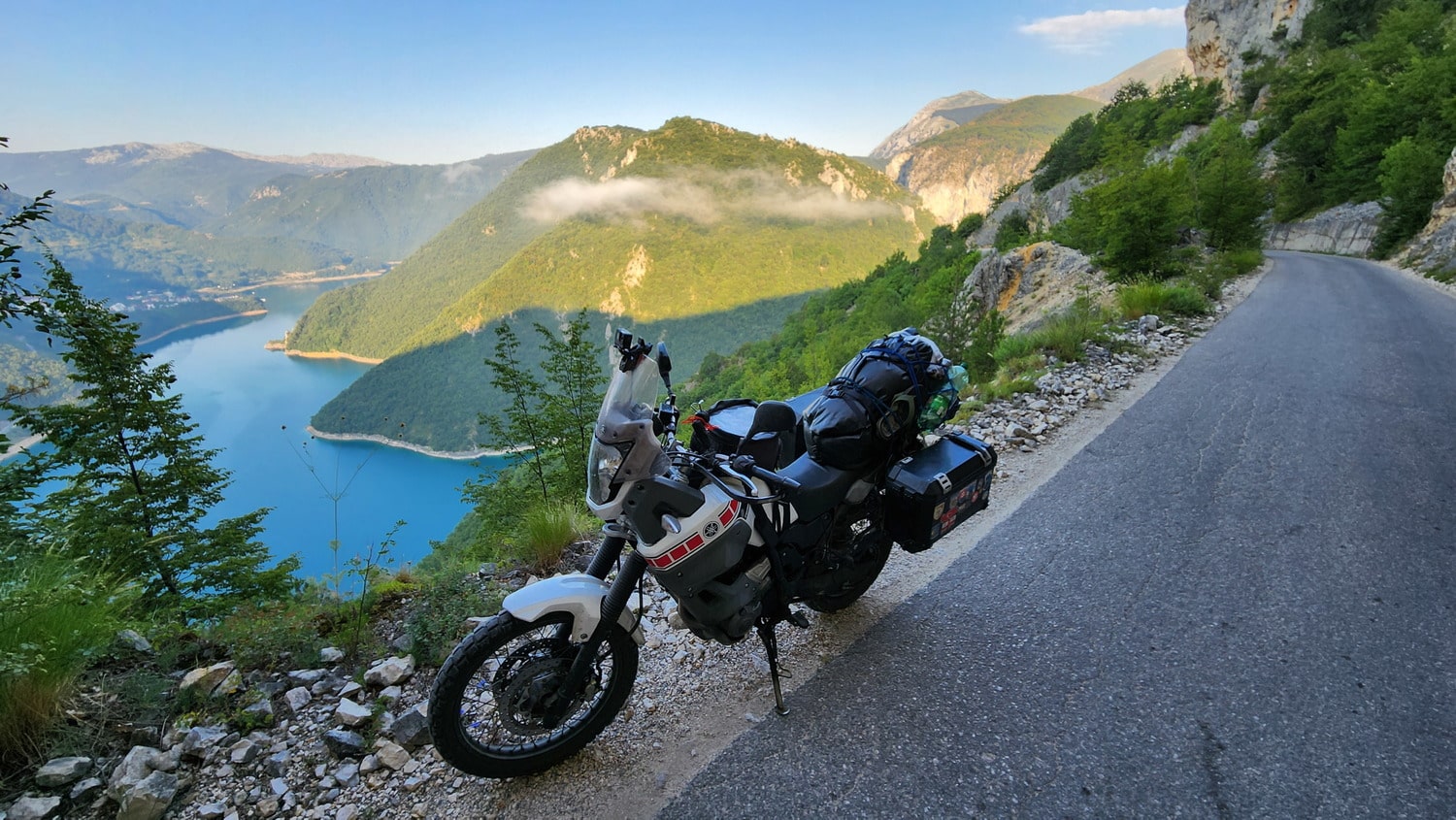 a motorcycle parked high above a lake