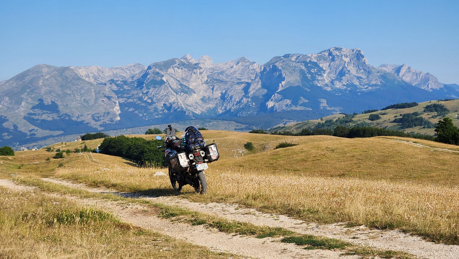 a motorcycle with mountain peaks behind