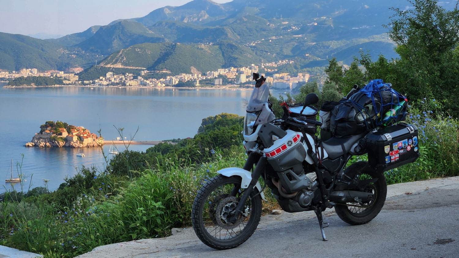 motorcycle with a tiny island connected to the mainland by a sandbar