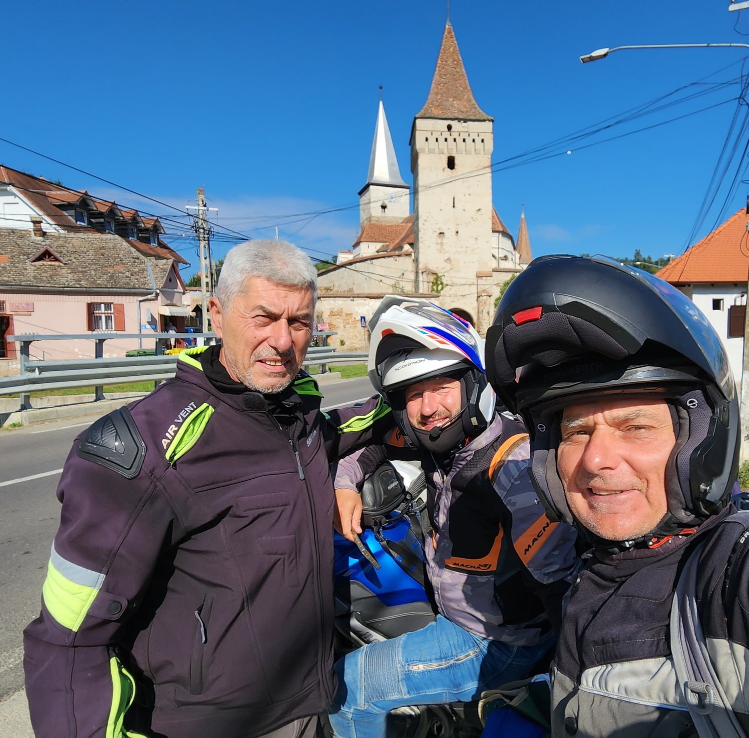 three riders with a medieval castle behind