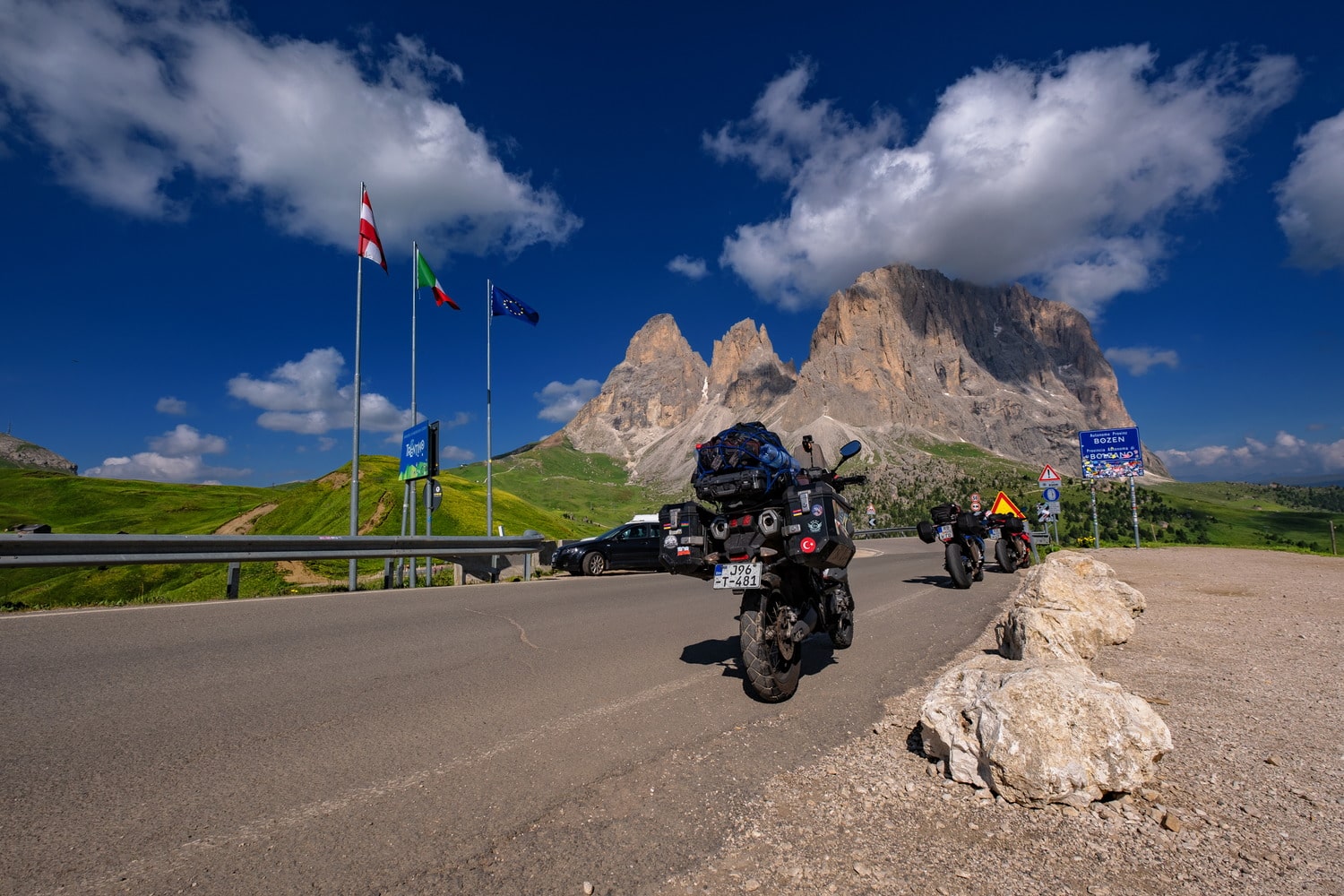 motorcycle parked with a huge rock mountain behind