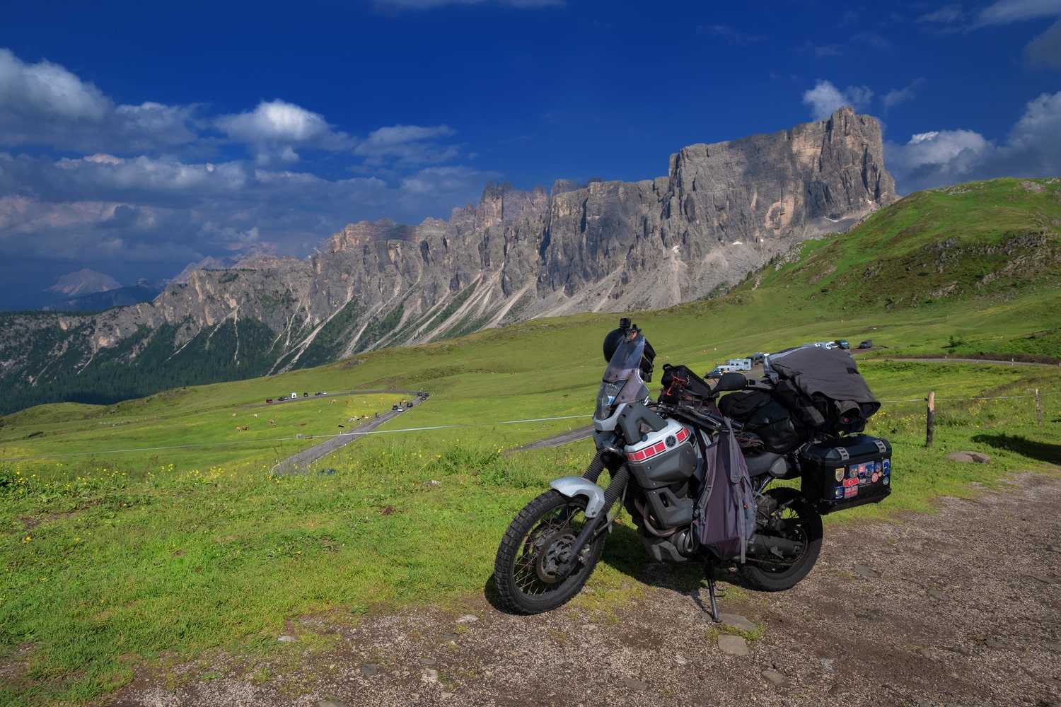 motorcycle parked with jagged mountains behind