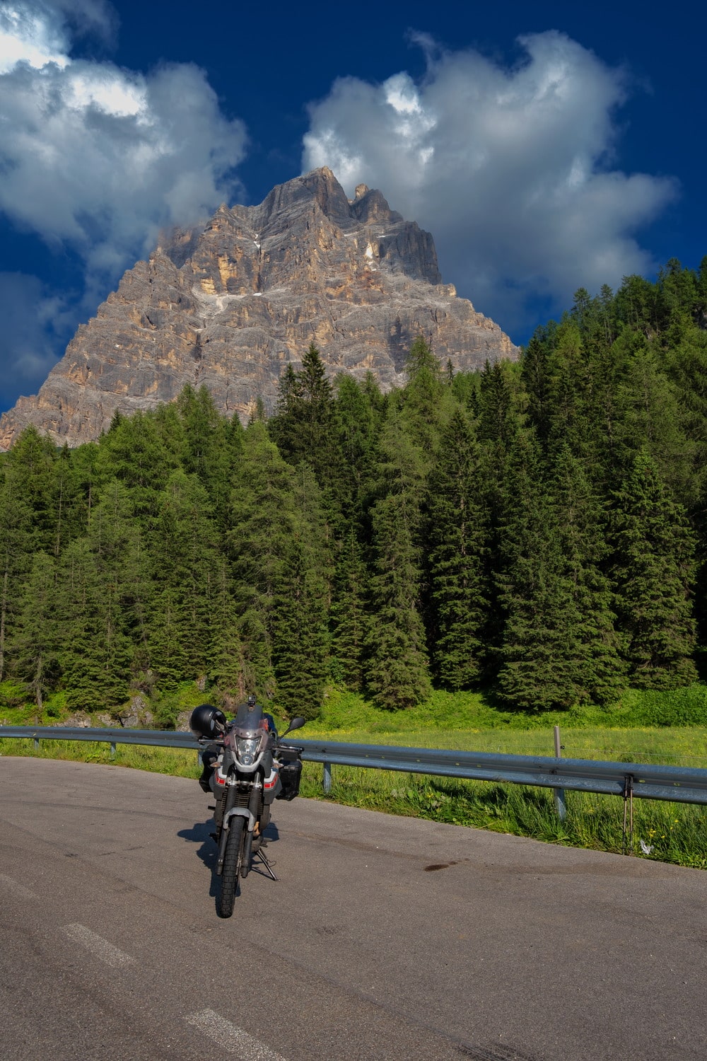 motorcycle parked with snowy peak behind