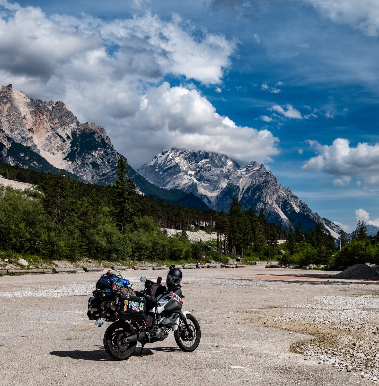 motorcycles on a road with mountains behind