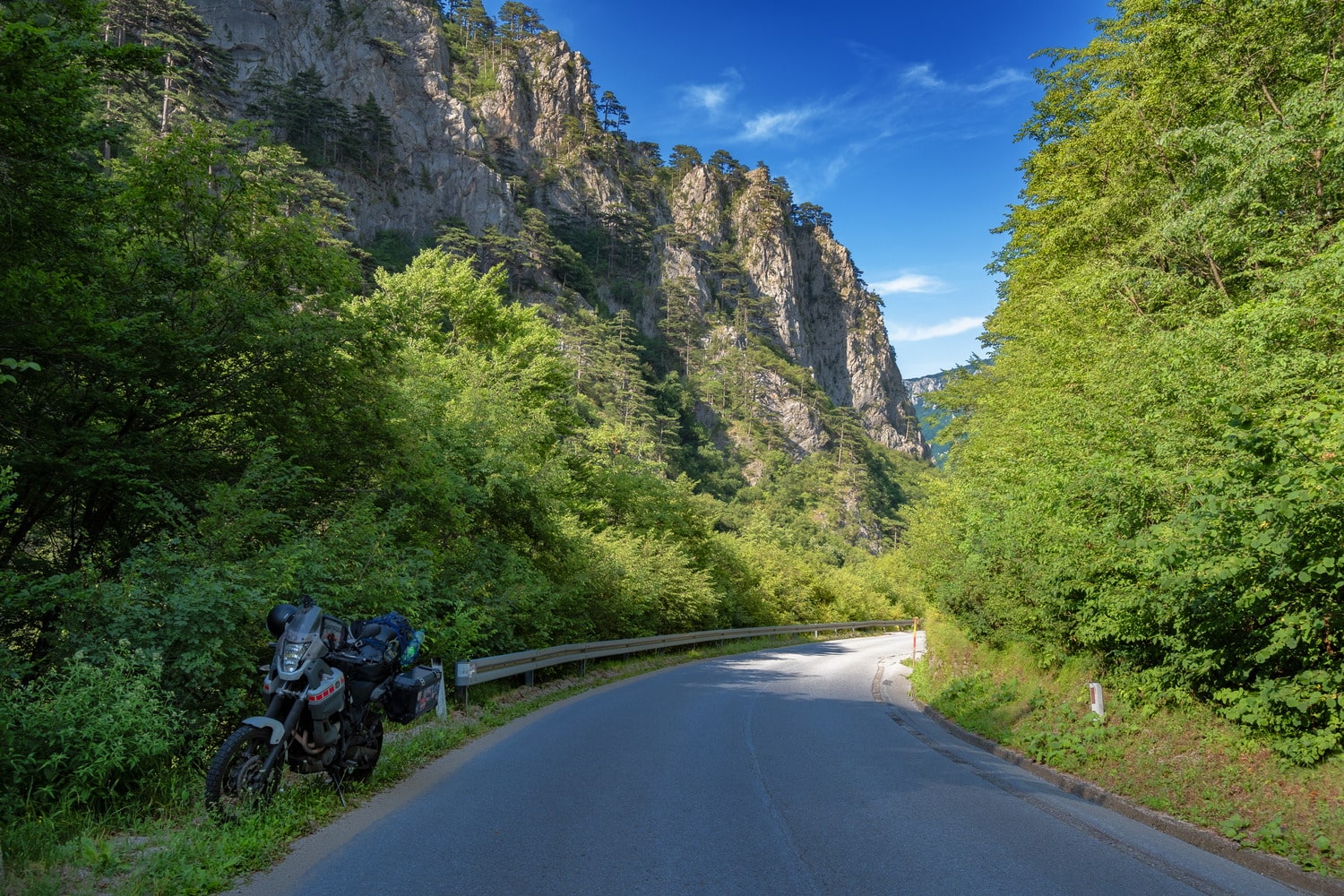 motorcycle parked in a canyon with steep rock walls