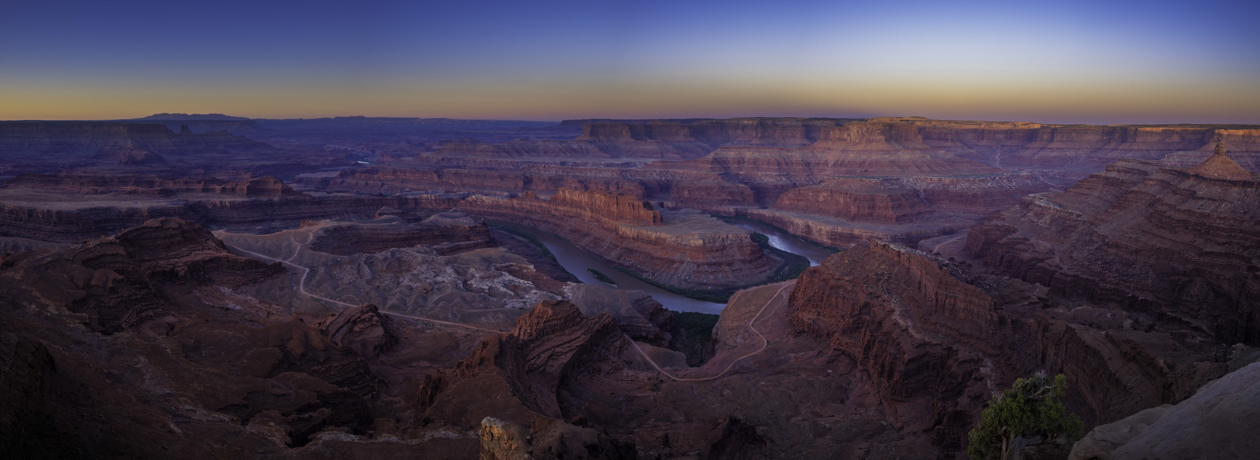 a view of the white rim trail and surrounding canyons